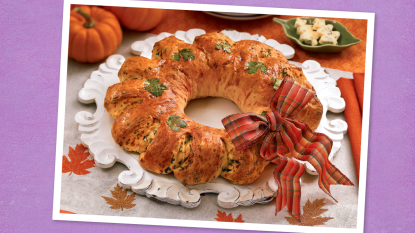 Herbed Cheese Bread Wreath sits on a purple background (Thanksgiving appetizers)