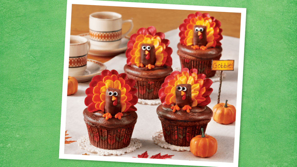 Turkey Cupcakes sits on a green background (Thanksgiving cupcakes)