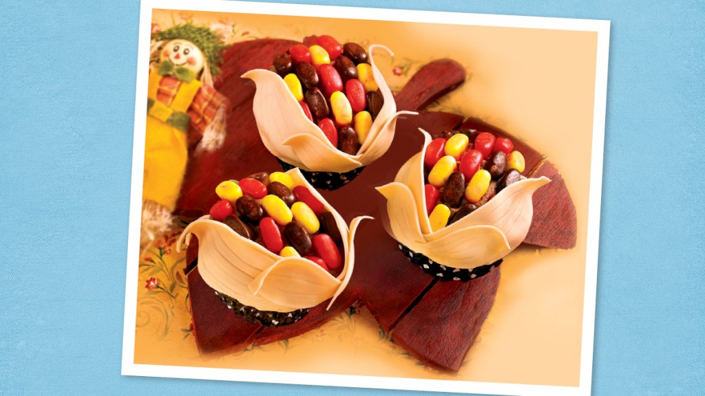 Indian Corn Cupcakes with Chocolate Buttercream sits on a blue background (thanksgiving cupcakes)
