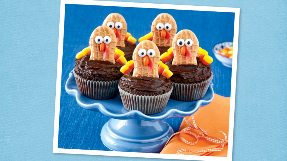 Nutter Butter Turkey Cupcakes sits on a blue background (Thanksgiving cupcakes)