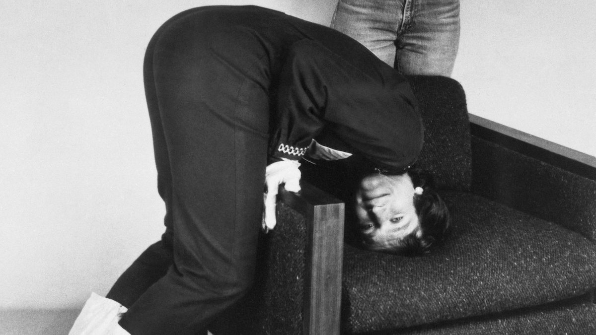 Robin Williams attempting head stand, 1979