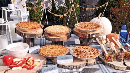 Pie party: Lead buffet table filled with fall pies and table is dressed with a plaid cloth and pie toppings