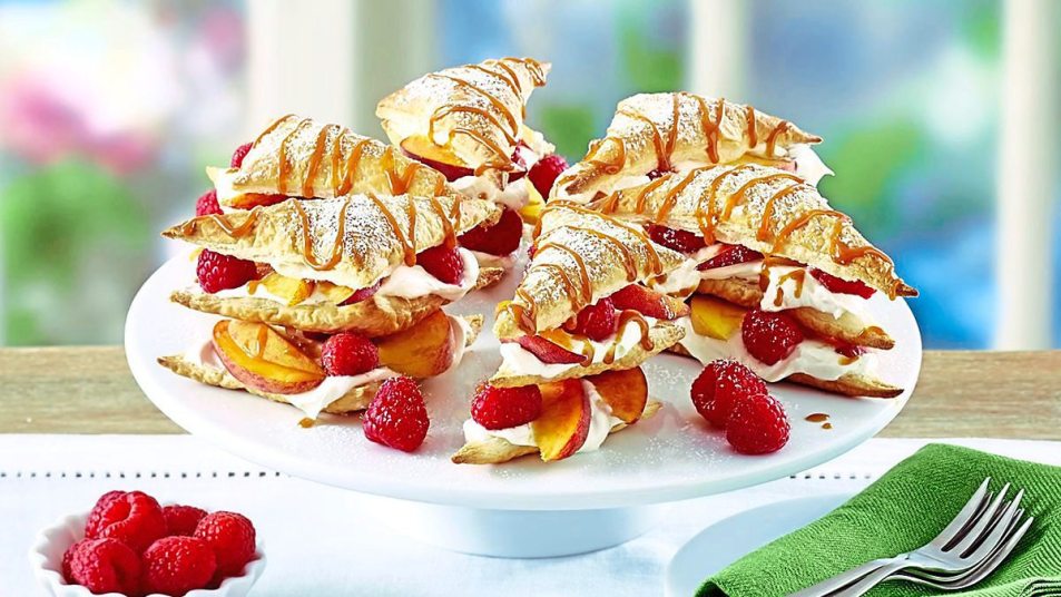 Peaches-and-Cream Puff Pastry Napoleons sits on a white plate (Easy desserts with few ingredients)