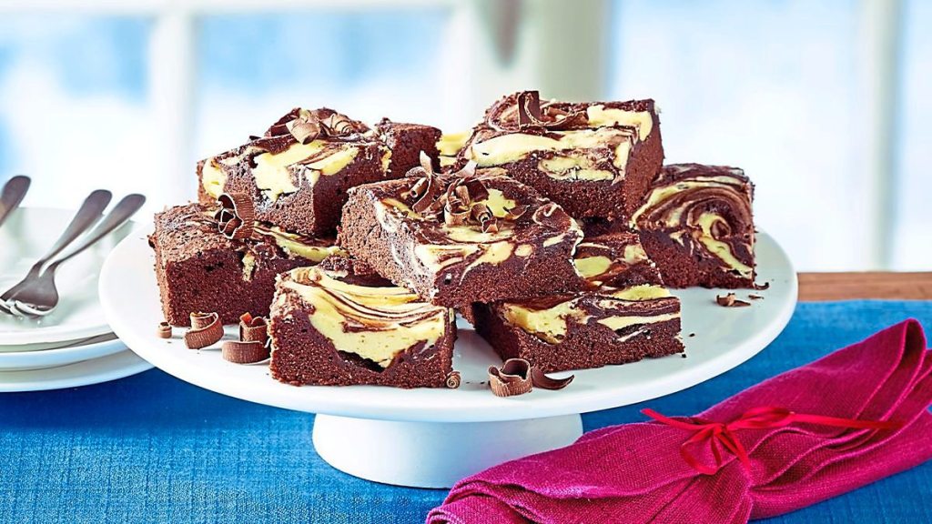Cheesecake Swirl Brownies sits on a white plate (Easy desserts with few ingredients)