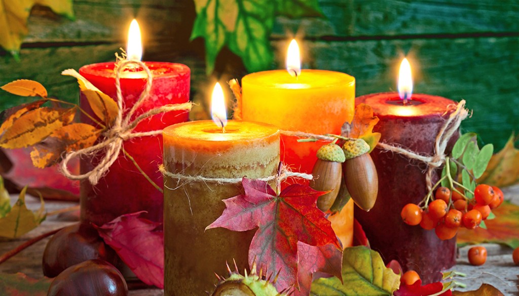 Friendsgiving: Autumn candles with leaves vintage abstract still life in night