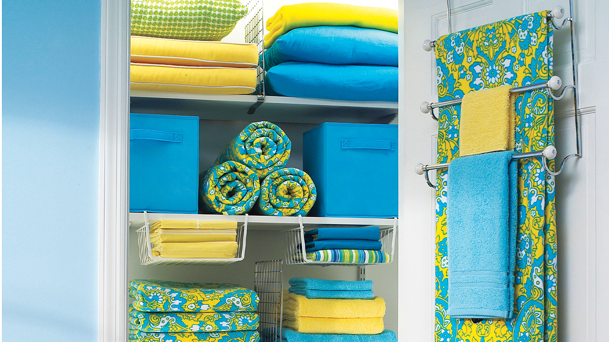organized linen closet with under shelves