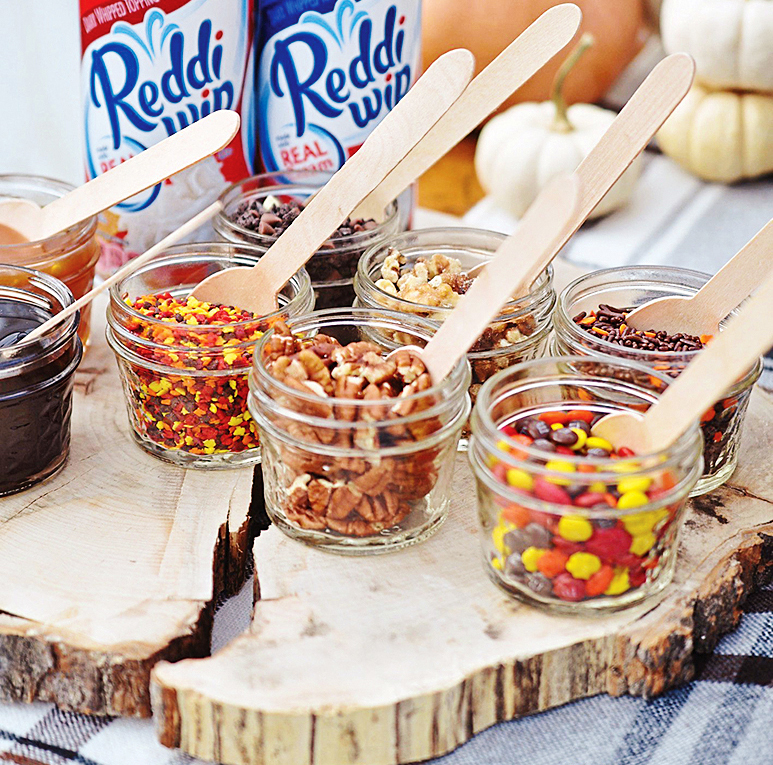 Pie party: tasty toppings bar that shows candy in little mason jars with spoons to add to pie slices