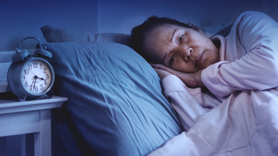 Woman laying in bed and having trouble sleeping