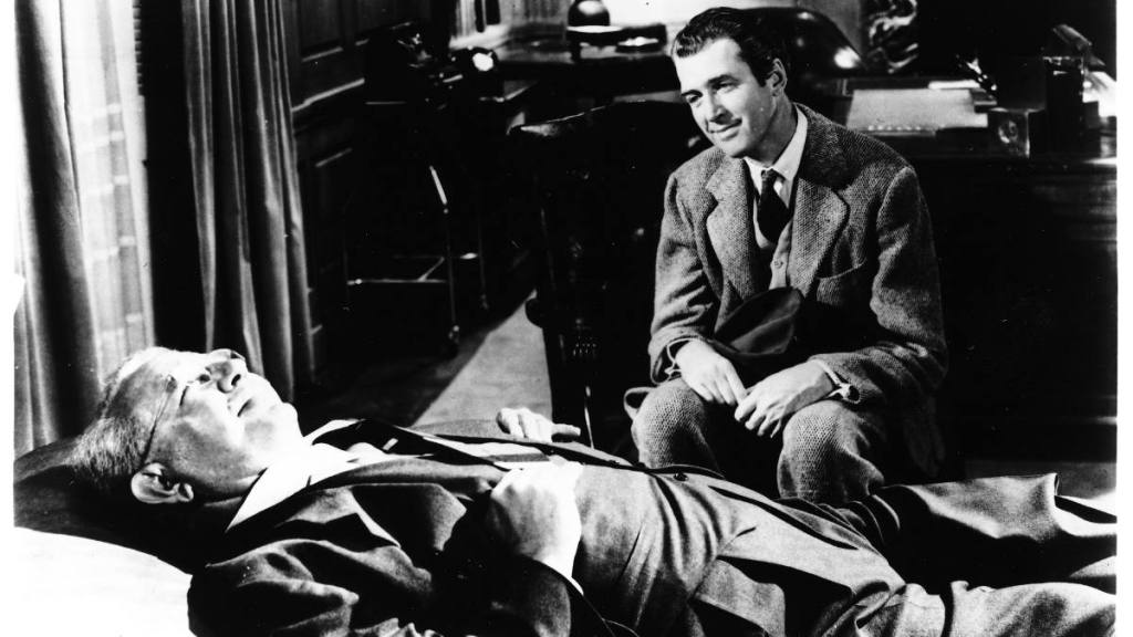 Jimmy Stewart Movies: James Stewart looking over Charles Drake in “Harvey”
