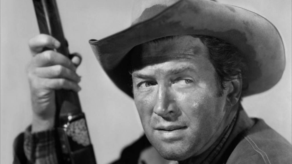 Jimmy Stewart Movies: Jimmy Stewart posing with a rifle in “Winchester ’73”