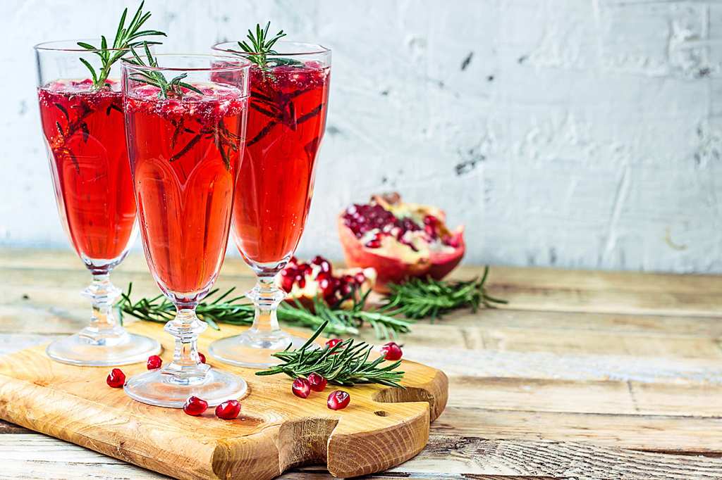 Holiday party: berry bubbly punch in flutes displayed on table for Christmas party