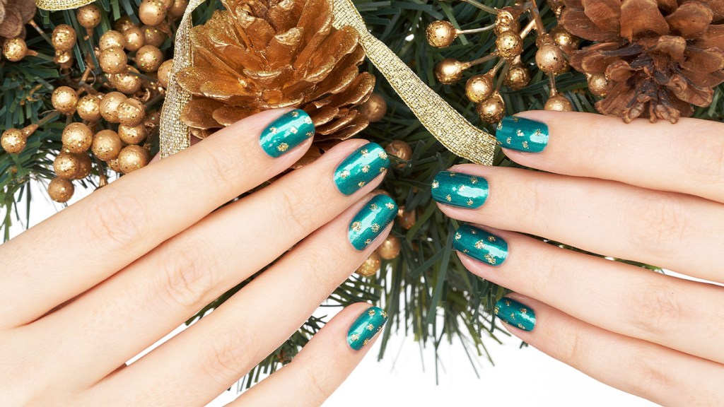 Nails painted emerald green with gold polka dots, one holiday nail ideas