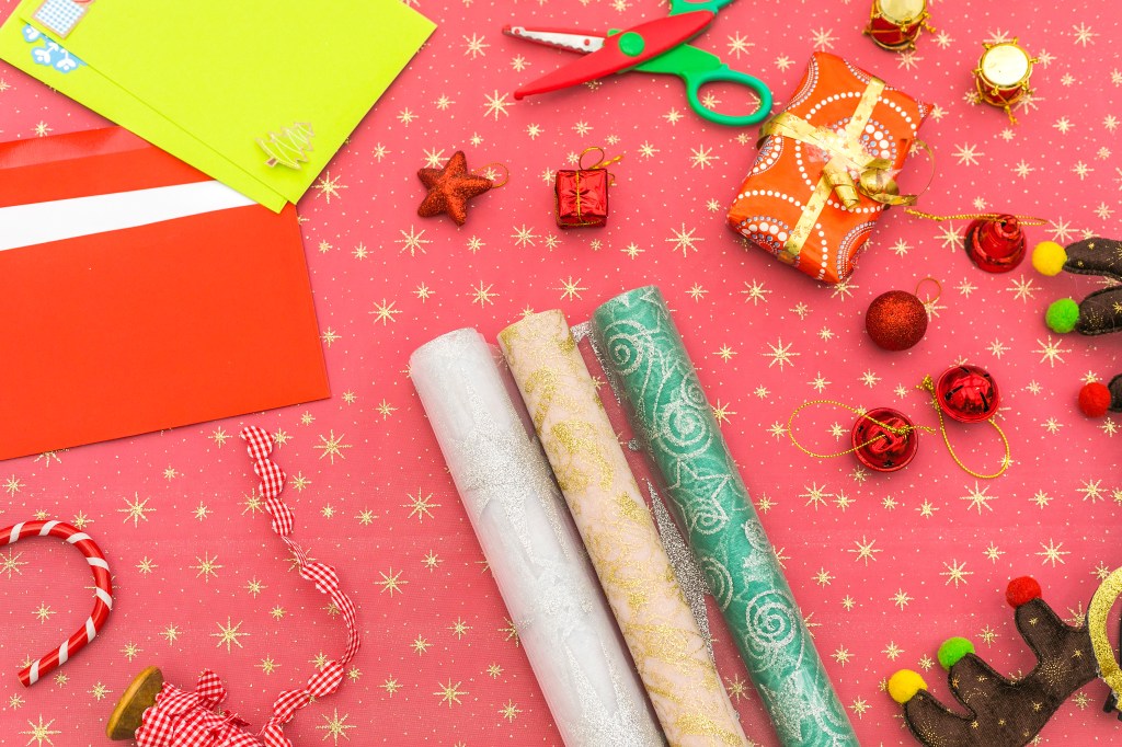 Holiday party: flat lay xmas background gift wrapping supplies on table for holidays