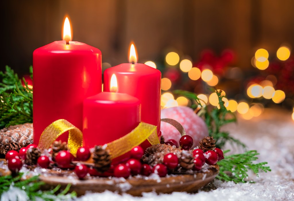 Holiday party: Christmas candles on rustic wooden table. 