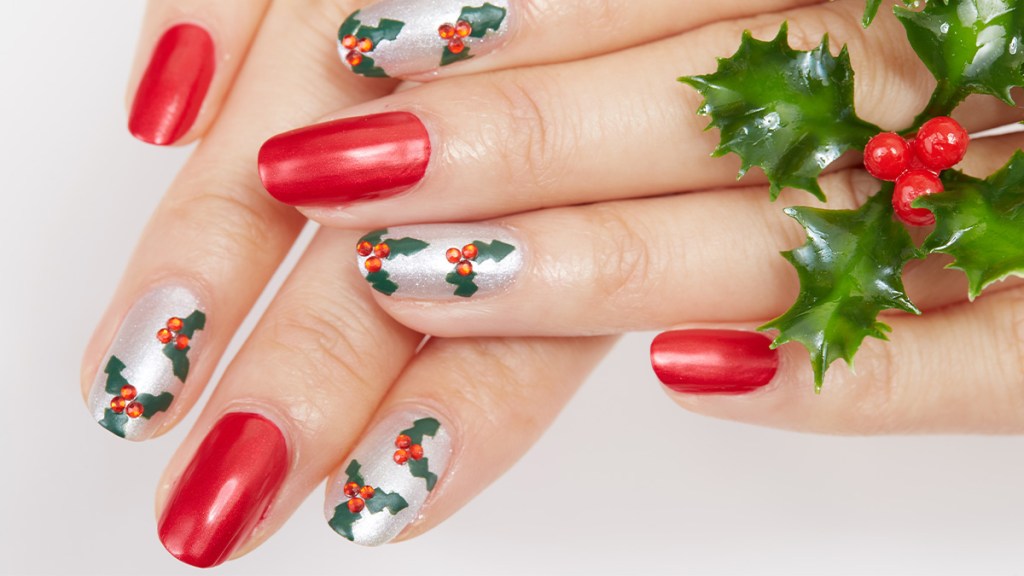 Nails painted red and silver with holly accents, one holiday nail ideas