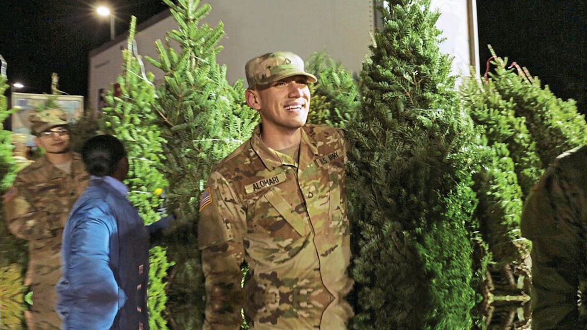 Soldiers carrying out trees and spreading Christmas cheer
