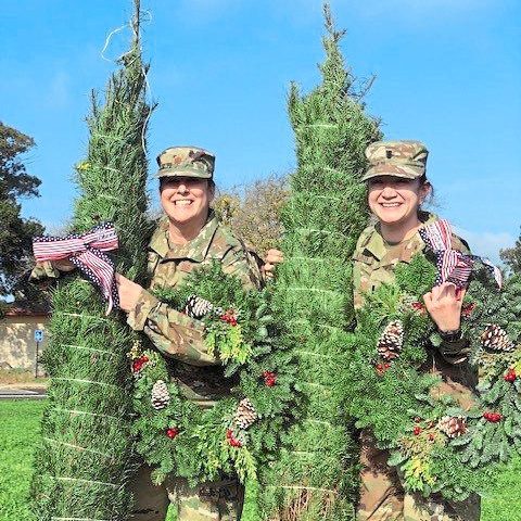 Two soldier volunteers holding trees