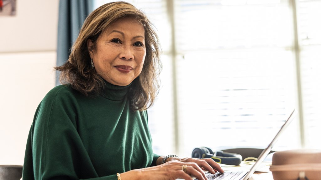 woman looking online for a work from job with AAA