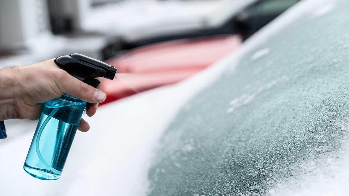 spraying an icy car windshield