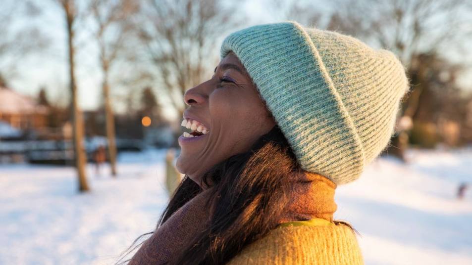Winter Jokes: a women in the snow laughing