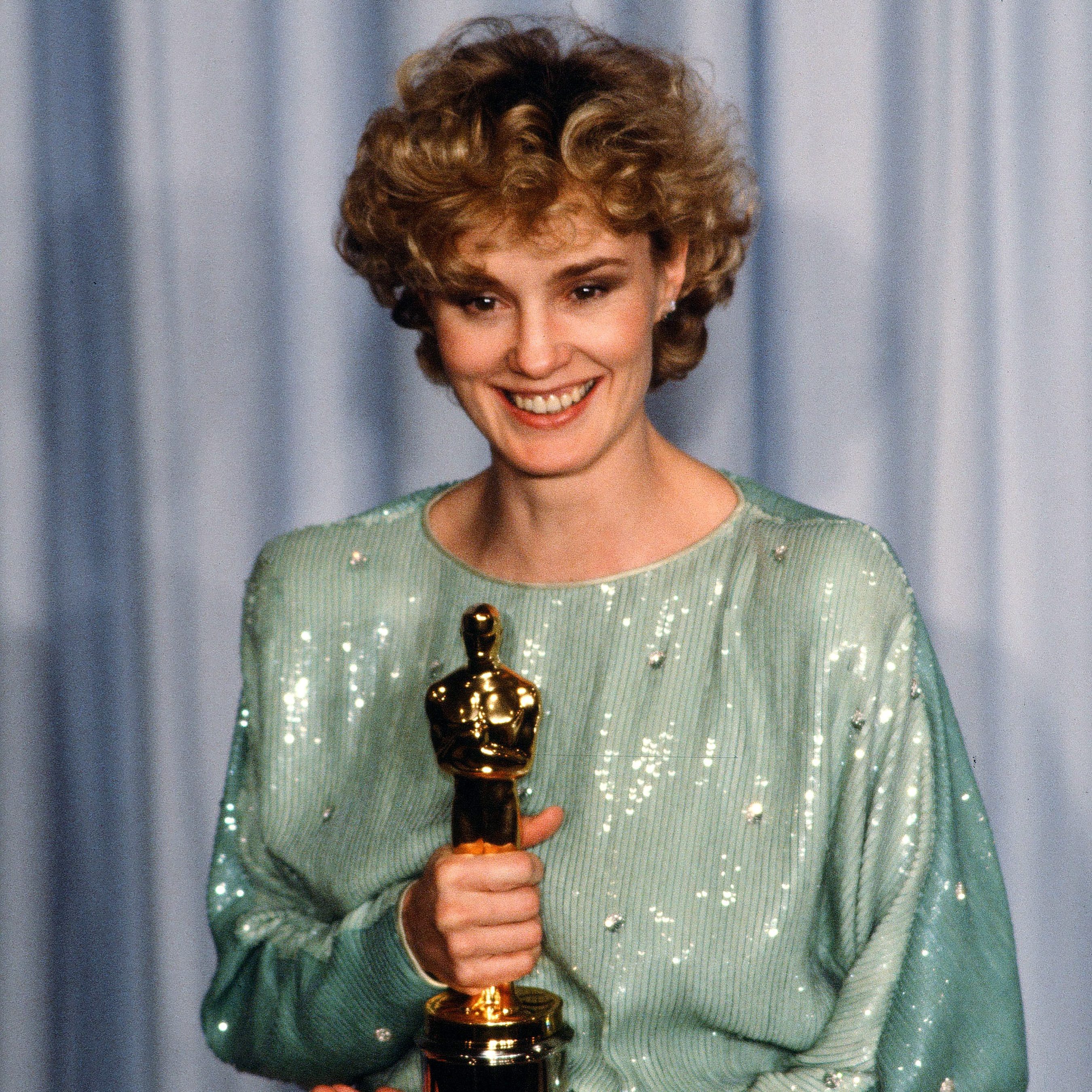Jessica Lange poses backstage after winning Best Supporting Actress at the 55th Academy Awards, 1983