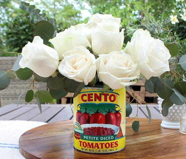 Pizza party: supermarket flowers in recycled tomato cans