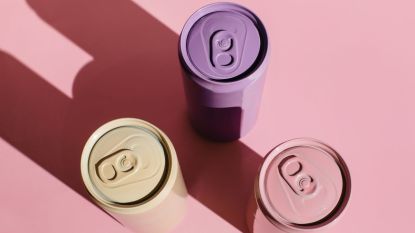 Pink, beige, lilac prebiotic soda cans on pink background
