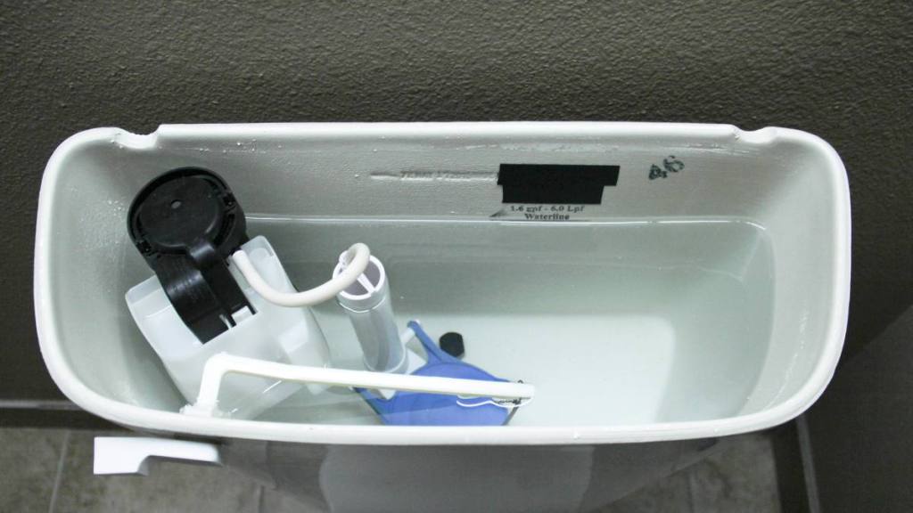 How to Clean Toilet Tank: Internal plumbing of the inside of a tank of a modern toilet