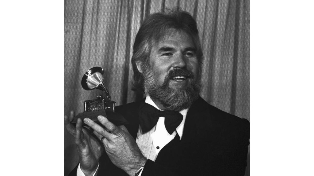 Man holding grammy award
