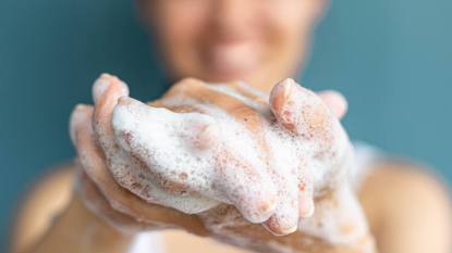 Germ Hot Spots: Closeup shot of person's hands being washed with soap suds