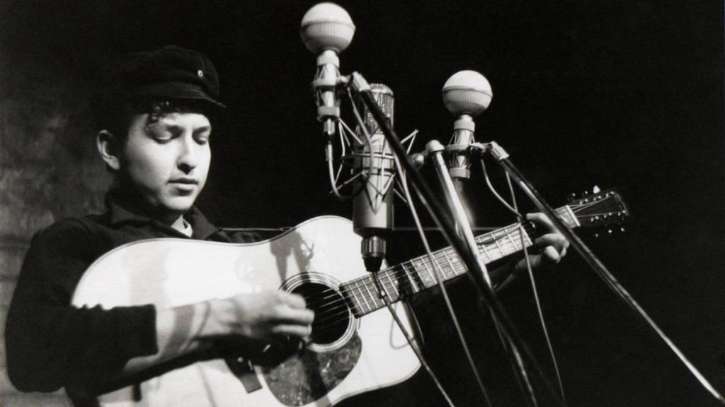 Bob Dylan playing guitar; young bob Dylan