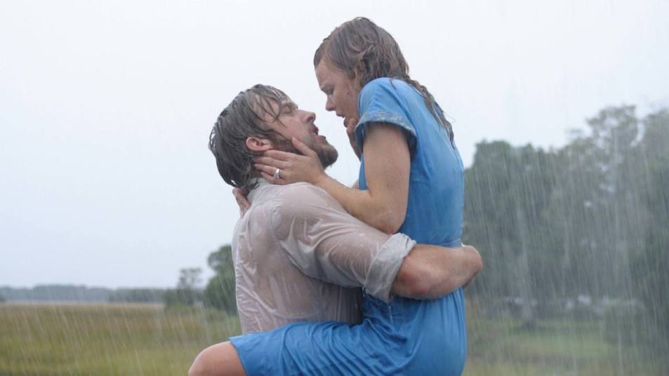Man holding a woman in the rain