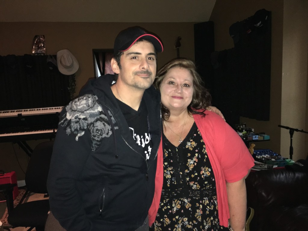 Deborah with Brad Paisley (left) who is featured in Country Faith