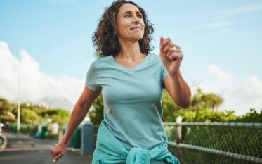mature woman outside walking after easing back pain