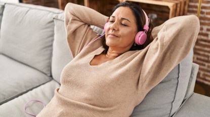 Woman relaxing and listening to music on headphones