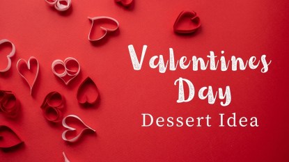 Pink and red paper hearts arranged on a red background with white text that reads 'Valentine's Day Dessert Idea.'