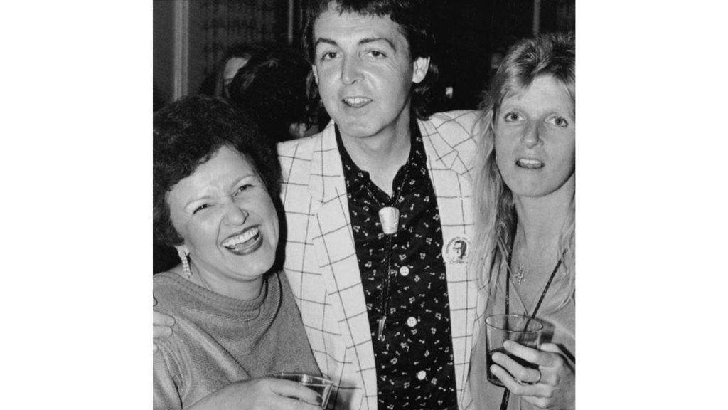 Two woman and a man smiling for a photo