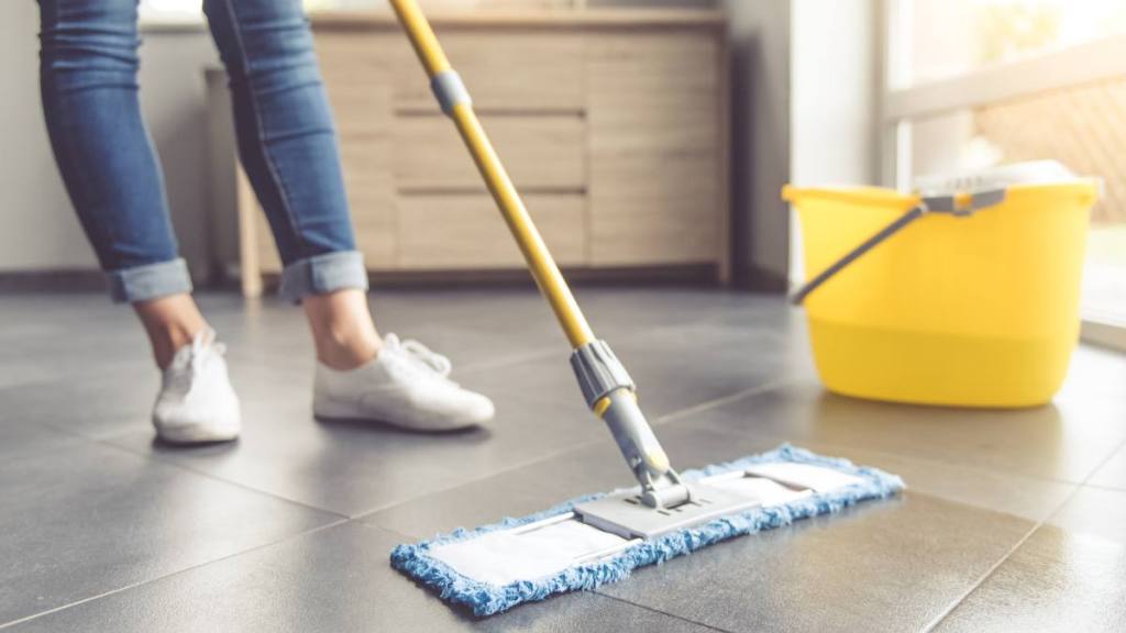 spring equinox 2024: Woman spraying aromatic air freshener indoors closeup Cropped image of beautiful young woman in protective gloves using a flat wet-mop while cleaning floor in the house