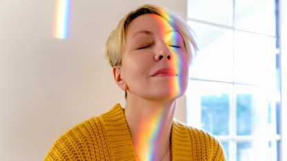 Mature woman with aura light reflection on face