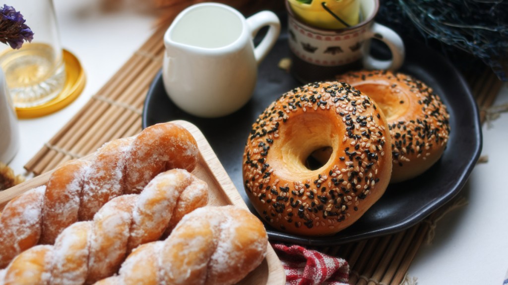 Sugary pastries next to sesame bagels on a plate, which can cause you to fall asleep after eating as a sign of diabetes