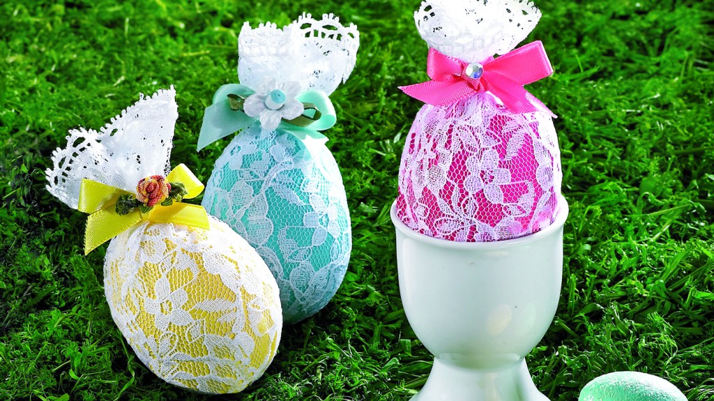Cool Easter egg designs: Three colorful Easter eggs wrapped in lace and tied with ribbon