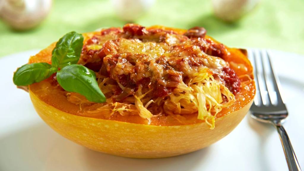 how to lose weight and build muscle for women: Spaghetti squash filled with tomato sauce and mushrooms, topped with cheese and baked