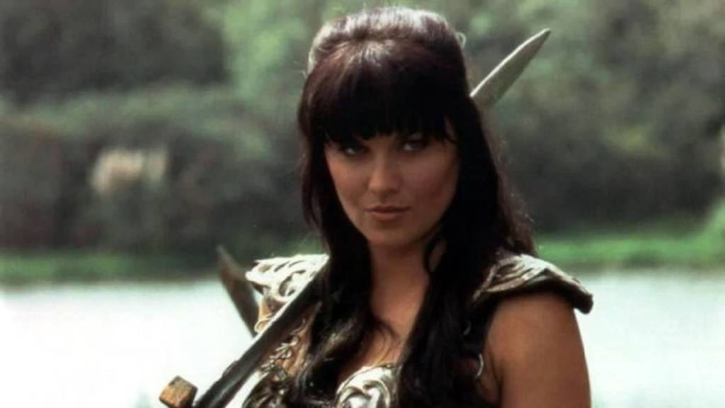 Woman in warrior costume with sword; Lucy lawless
