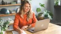 Highest paying work from home jobs: Mature adult woman working at home (laptop, mobile phone, document )