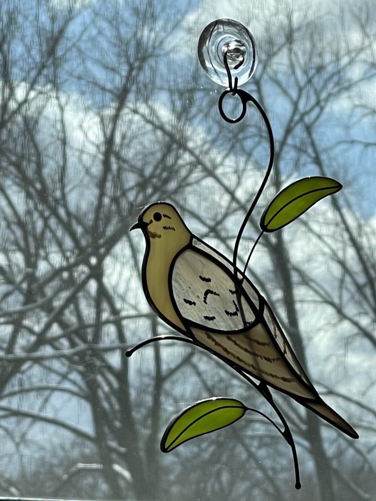 A stained glass mourning dove gift to Mary from her older daughter, Jill.