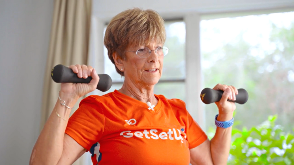 Woman using light weights to perform bone-strengthening exercise