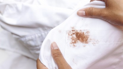 Woman holding a chocolate stained-shirt