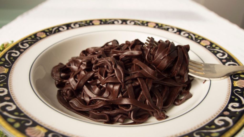 chocolate pasta in bowl with a fork