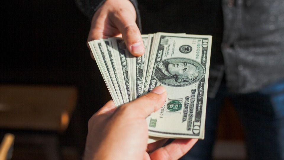 Two people exchanging cash