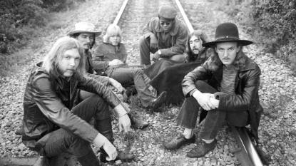 Allman brothers greatest hits; men sitting on train tracks